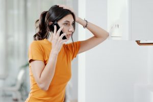 Woman calling emergency plumber help